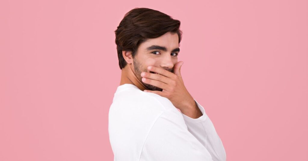恥ずかしそうに顔を覆いながらこちらを見つめる男性